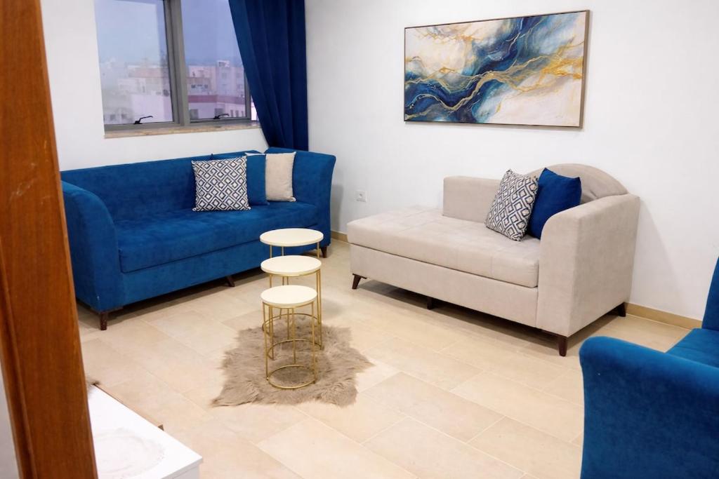 a living room with a couch and a chair at Jed appartement in Hammam-Lif
