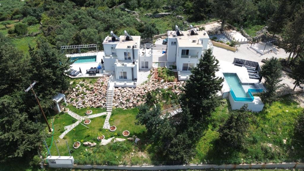 an aerial view of a house with a swimming pool at Armonia Complex in Gavalochori