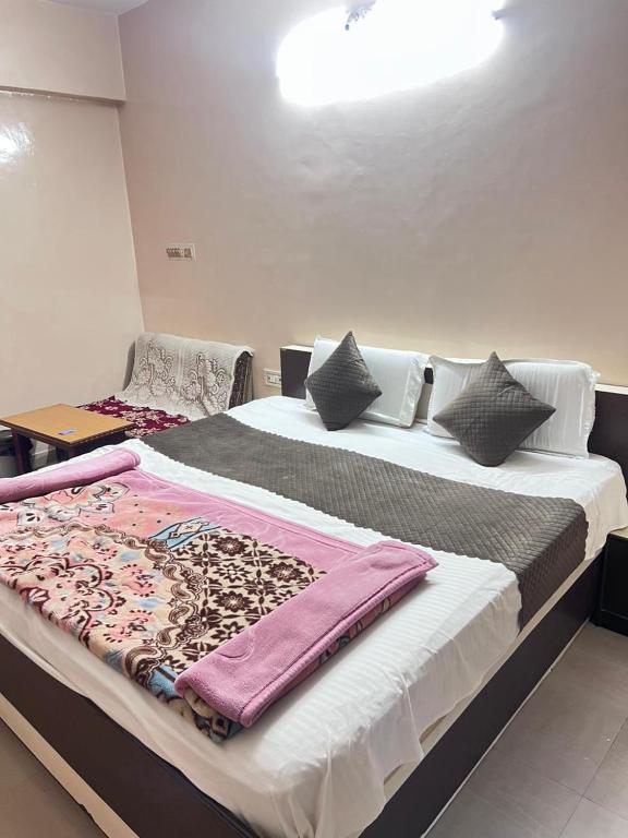 a bedroom with a large bed with towels on it at Shree Sanwariya Hotel in Chittaurgarh