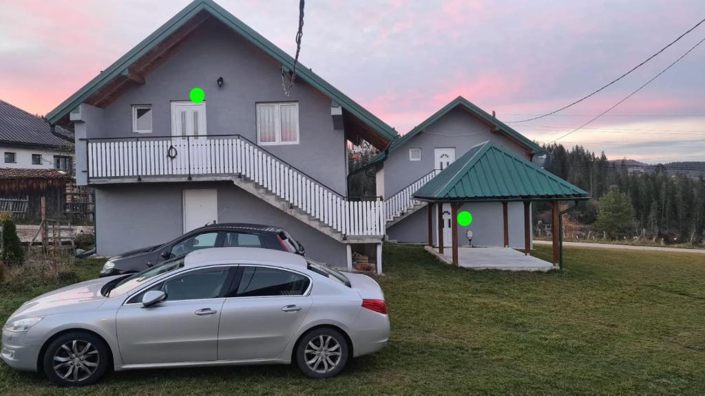a house with a car parked in front of it at Vikendica Popadić in Vukovina
