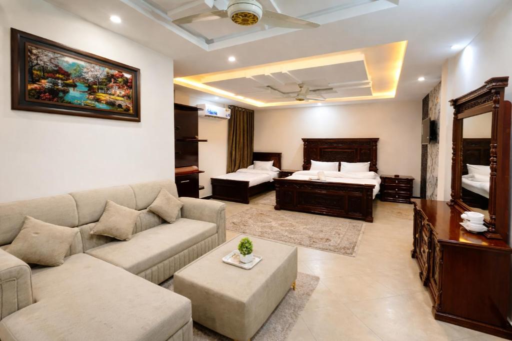 a living room with a couch and a bed at The Canvas Hotel in Abbottabad