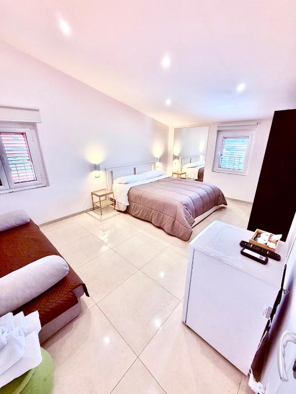 a bedroom with two beds and a desk in it at D ANNUNZIO house in Martinsicuro