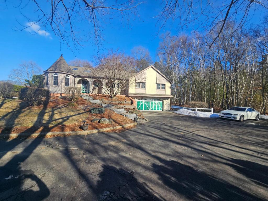 a house with a car parked in front of it at Dracut Executive Rooms with Kitchen & Bath, Parking, Spacious & Comfortable in Dracut