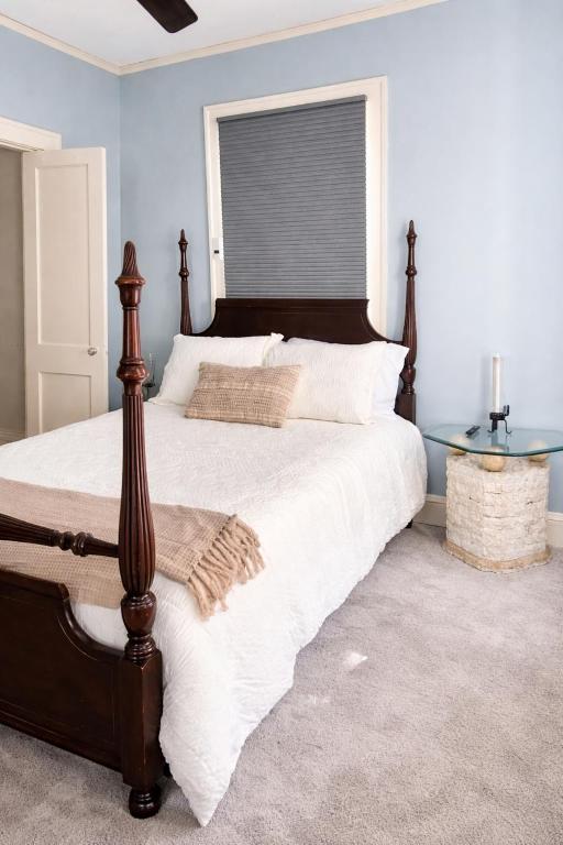 a bedroom with a large bed and a glass table at Town Square Charm Century Old in Lewisville
