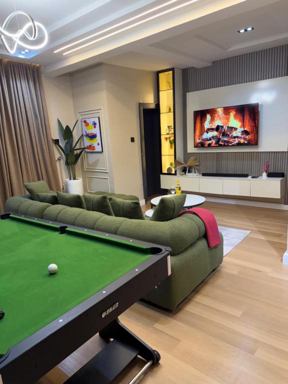 a living room with a pool table and a couch at Abuja Lux Apartment Wuye in Abuja