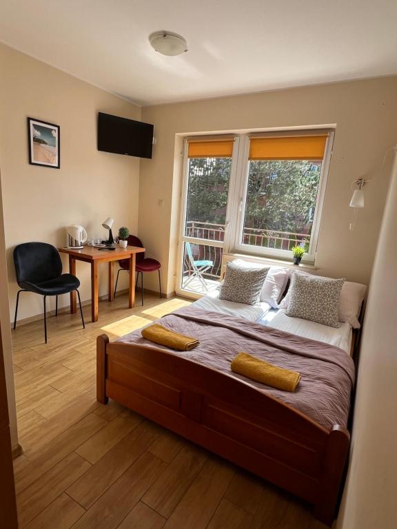 a bedroom with a large bed and a window at SAViTA in Karwia