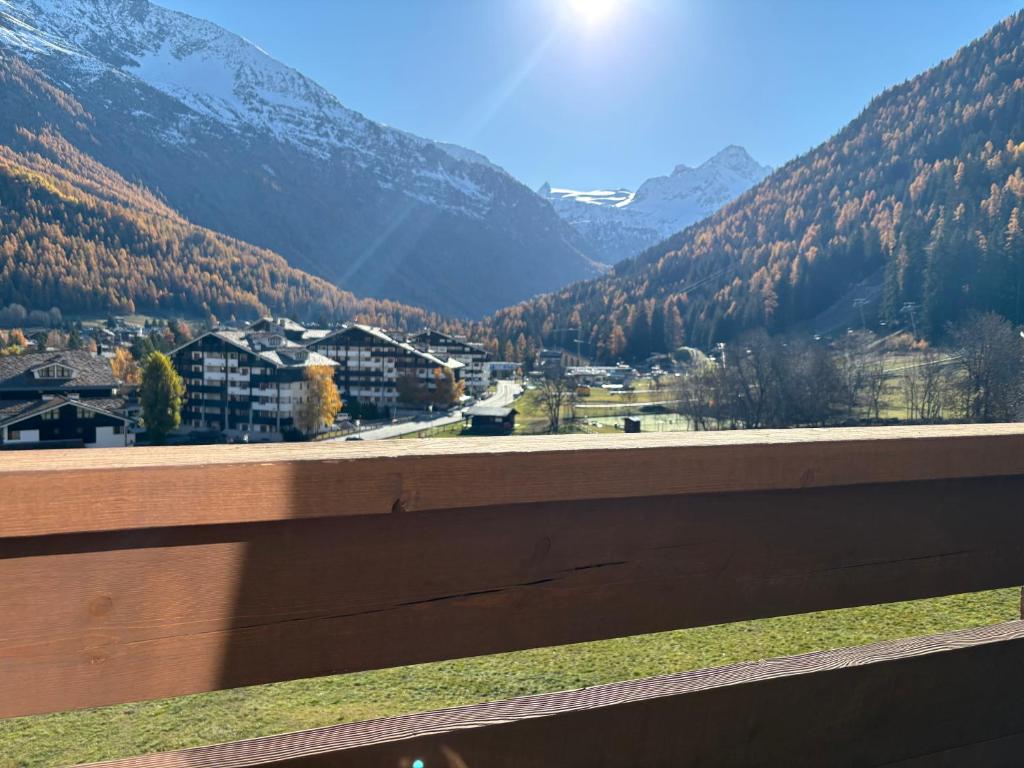 a view of a mountain valley from a fence at Casa Raggio di Sole in La Thuile
