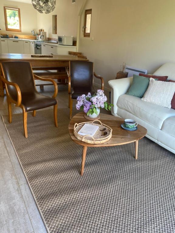 a living room with a couch and a coffee table at Les choses de la vie in Saint-Alvère