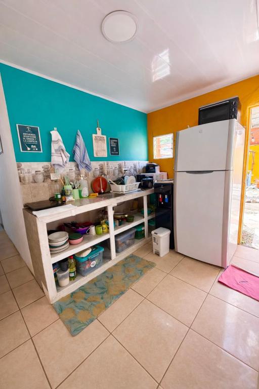 a kitchen with a white refrigerator in a room at Tico-living in Alajuela