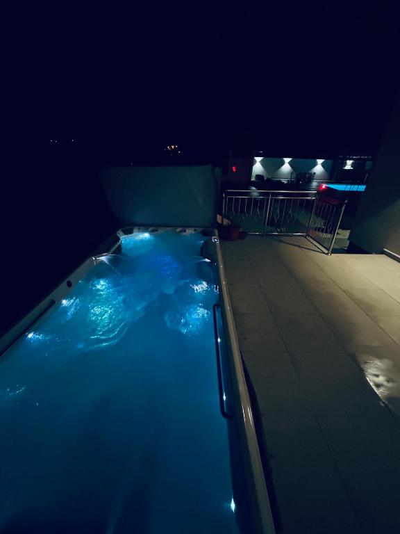a swimming pool at night with blue lights at Romantic Lodge -Private Swimm-Spa in Banja Luka