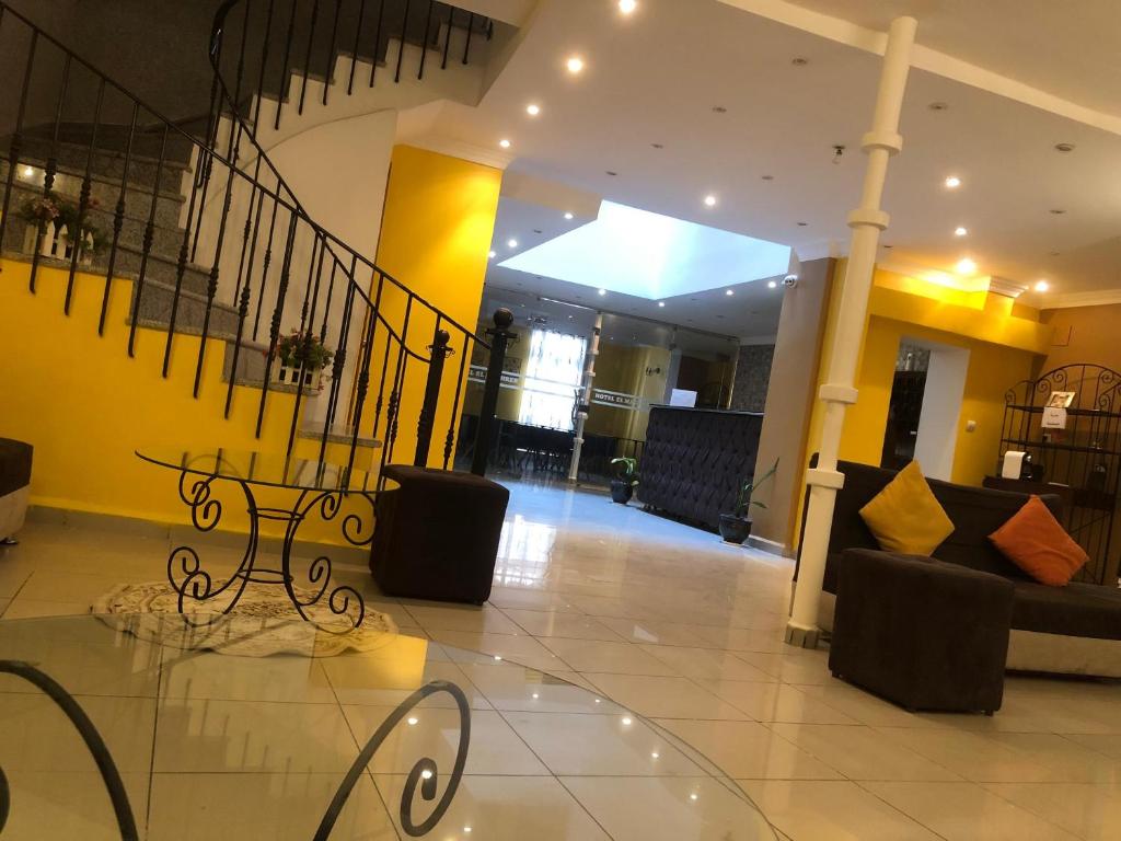 a lobby with a table and a couch in a building at Hotel El Maghreb in Constantine