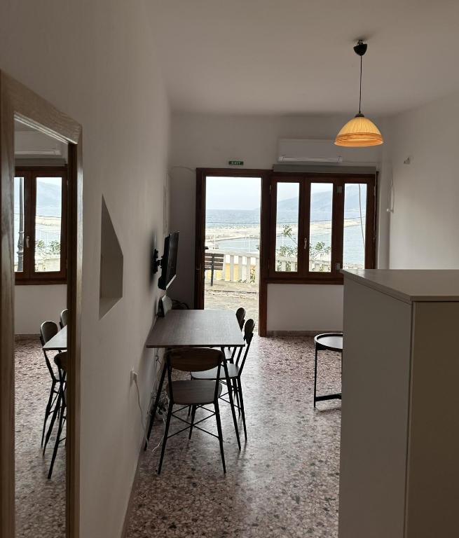 a living room with a table and chairs with a view at Evdilos Icaria 'Sto Plakostroto' by BRP-Properties in Evdilos