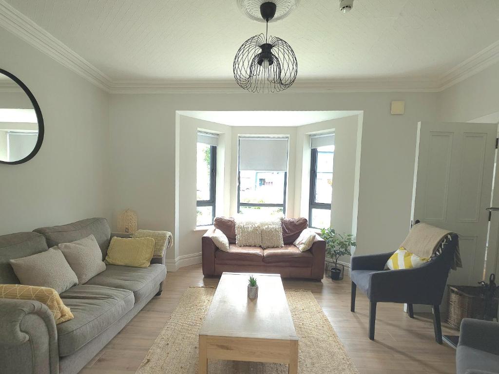 a living room with a couch and a table at The Wild Atlantic Townhouse in Enniscrone
