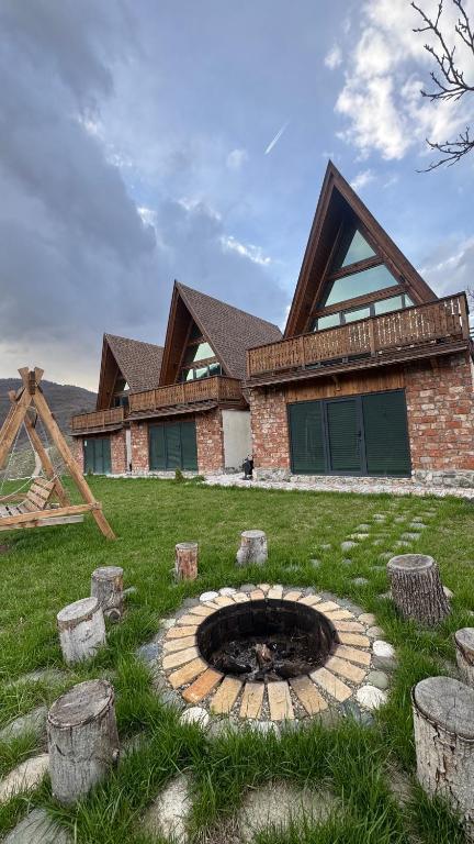 a house with a fire pit in the yard at Ditaket Dilijan in Dilijan