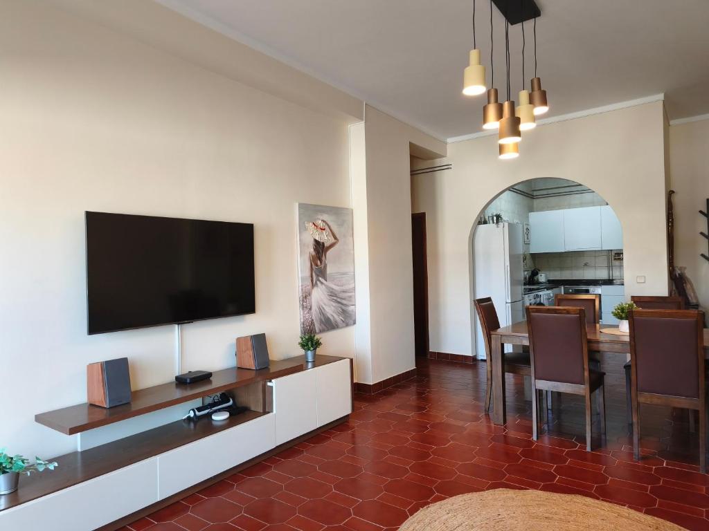 a living room with a flat screen tv on a wall at Apartment by the beach! With large balcony! in São Martinho do Porto