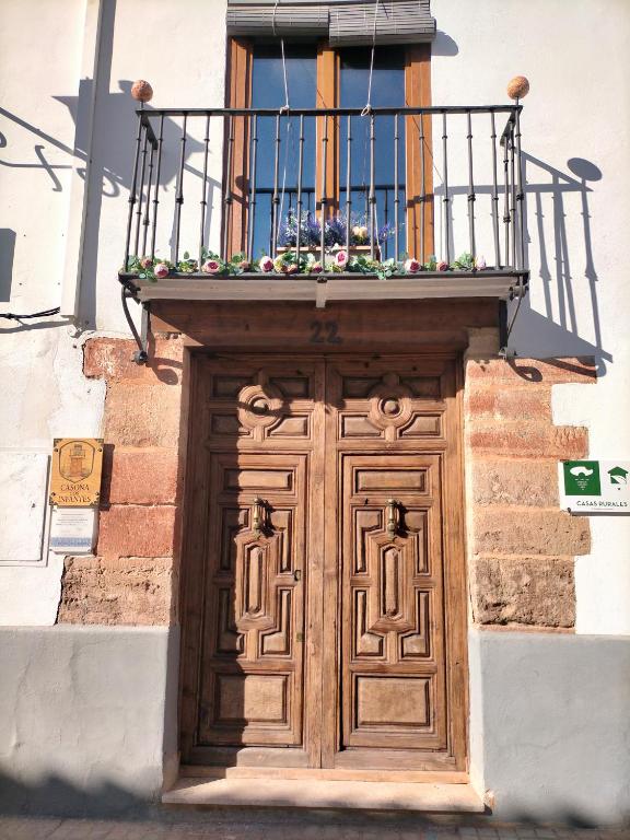 a wooden door with a balcony on top of it at Casona Los Infantes in Villanueva de los Infantes