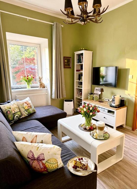 a living room with a couch and a coffee table at Nest Salzkammergut- Cozy Stay in Bad Aussee, Near Hallstatt - Garden & BBQ in Bad Aussee