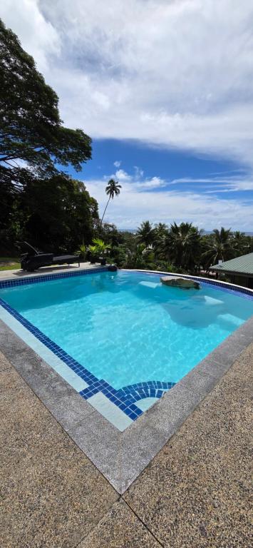 a large swimming pool with blue water at Ocean Beach Town View - Pool With Amazing Views! in Rarotonga