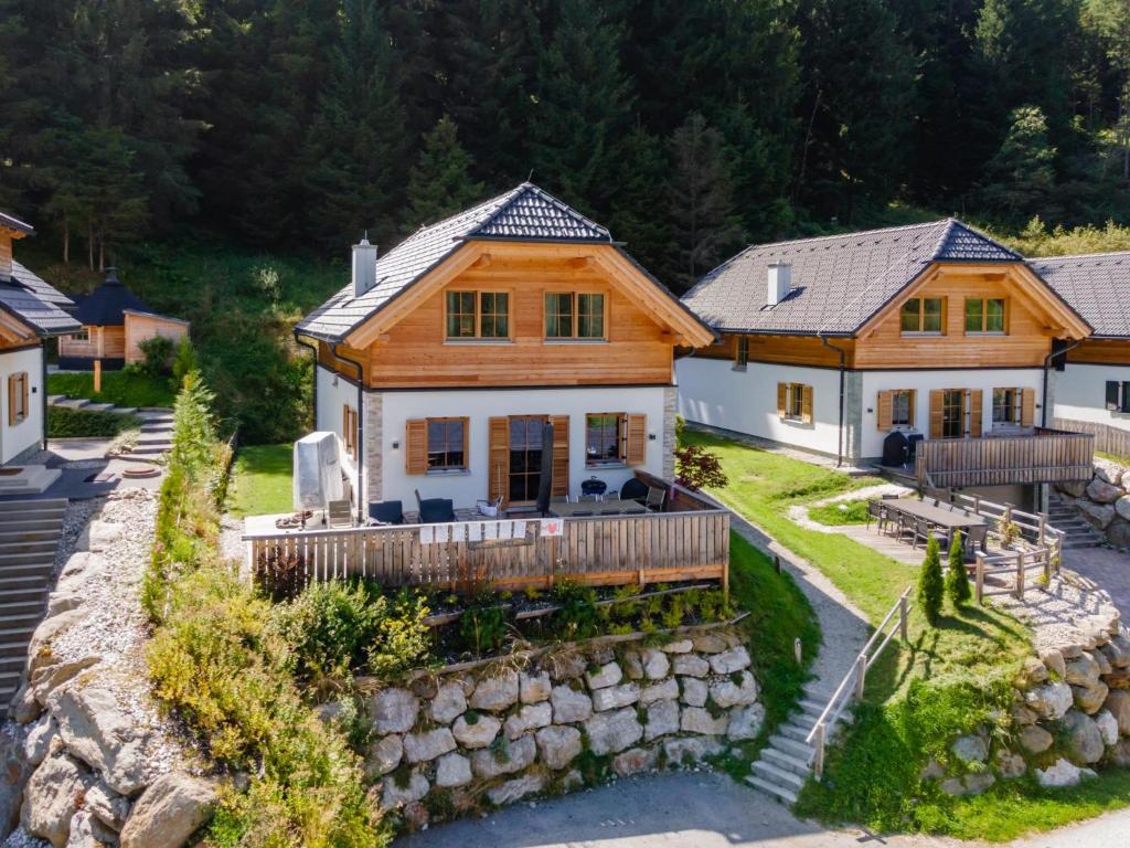 an aerial view of a house with a stone wall at Ahorn Mountainlodge in Donnersbachwald