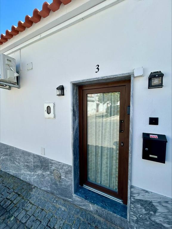 a door on the side of a white building at Casa do Picadeiro in Elvas
