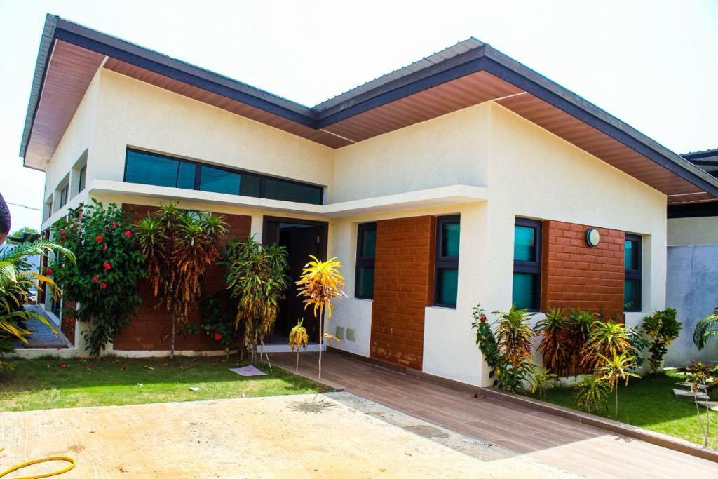 a house with a lot of plants in front of it at villa km19 in Assinie