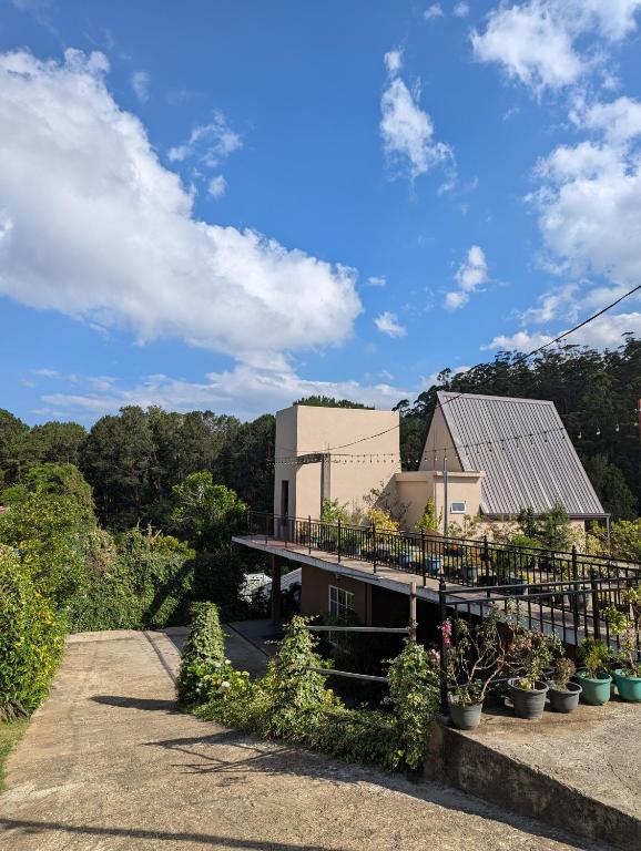 a view of a building with plants in front of it at Keshiya Holiday Home in Nuwara Eliya