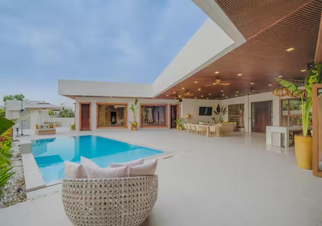 a swimming pool in the middle of a house at Villa Seresa Premium- La Union in Bacnotan