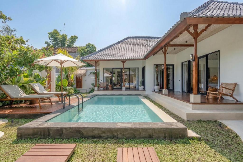 a villa with a swimming pool and a house at Sicilia Villa - Ubud Pool Stay with Open-Air Bath & Gazebo in Ubud