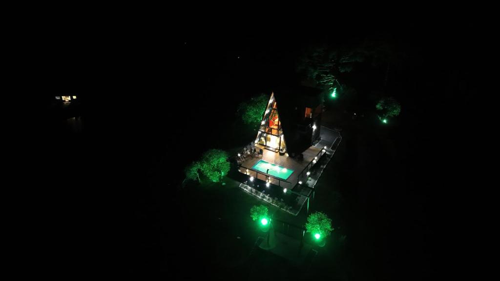 an overhead view of a building at night with green lights at Chalé Encantos do Frade in Bom Retiro