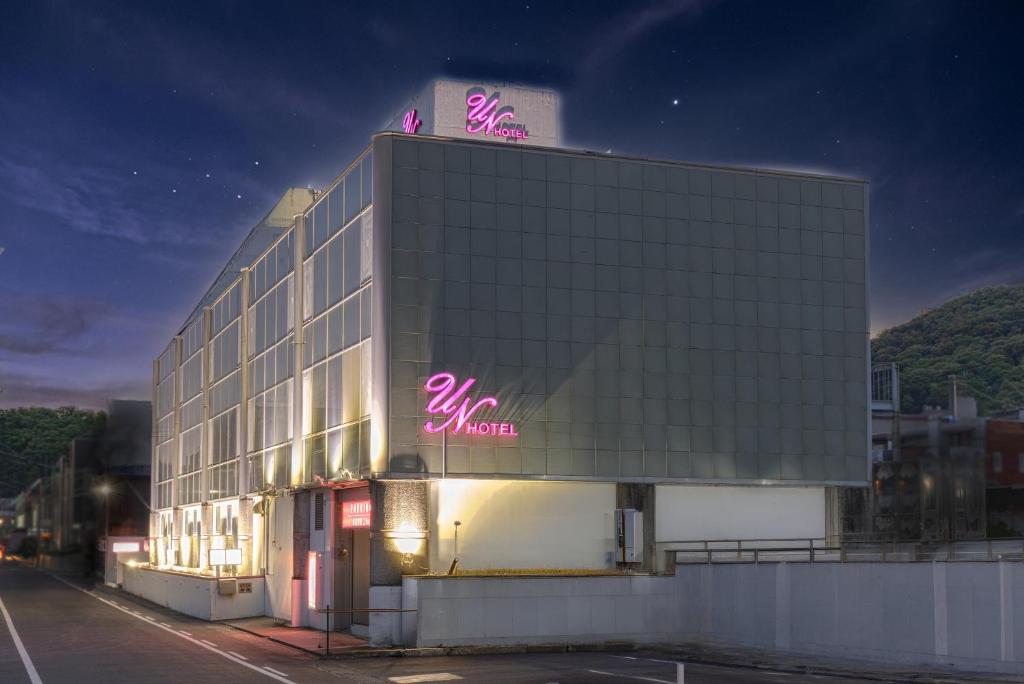 a building with a neon sign on top of it at ホテル アン 岐阜-大人専用 in Gifu