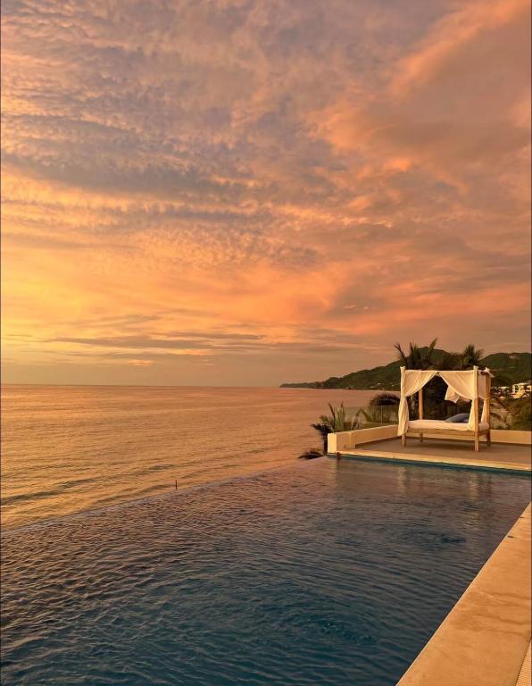 a pool with a wedding set up on the beach at Apartamento en Punta Mita in Higuera Blanca