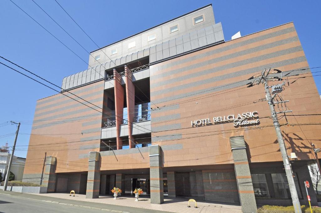 a building with a sign on the side of it at ホテルベルクラシック北見 in Kitami
