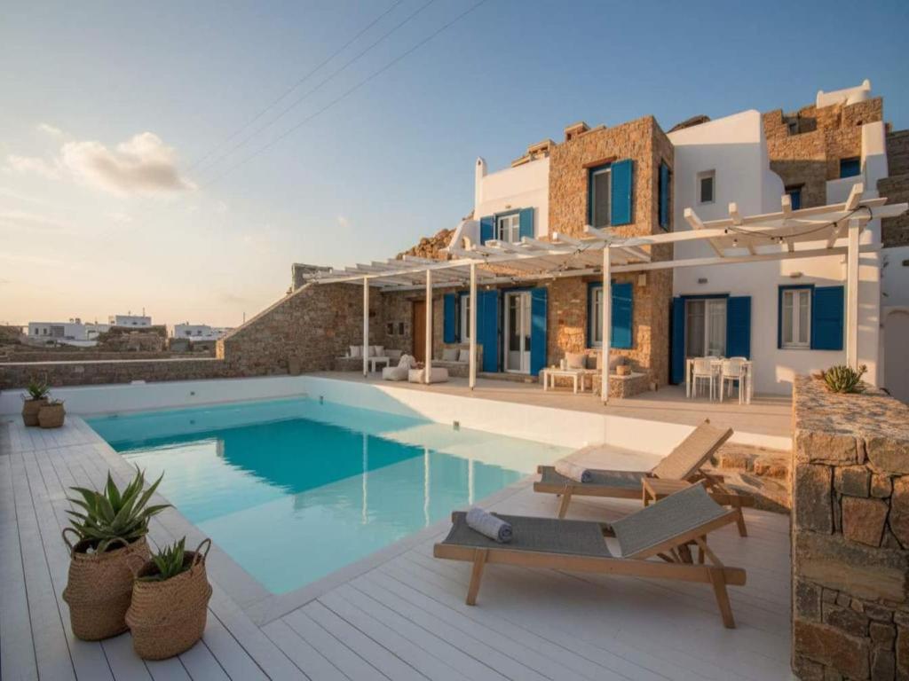 a villa with a swimming pool and a house at Mykonos Villa for 8 with Pool in Mikonos