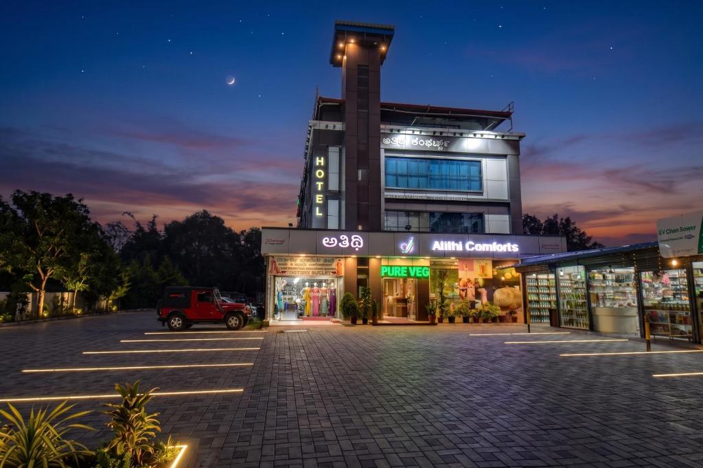 an empty parking lot in front of a building at Atithi Comforts in Kushālnagar