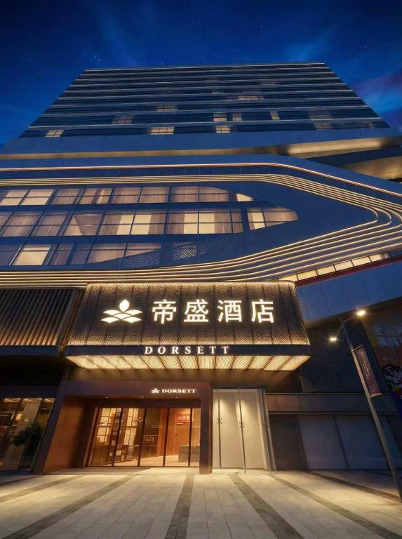 a large building with a sign on the front of it at Dorsett Wuhan in Wuhan