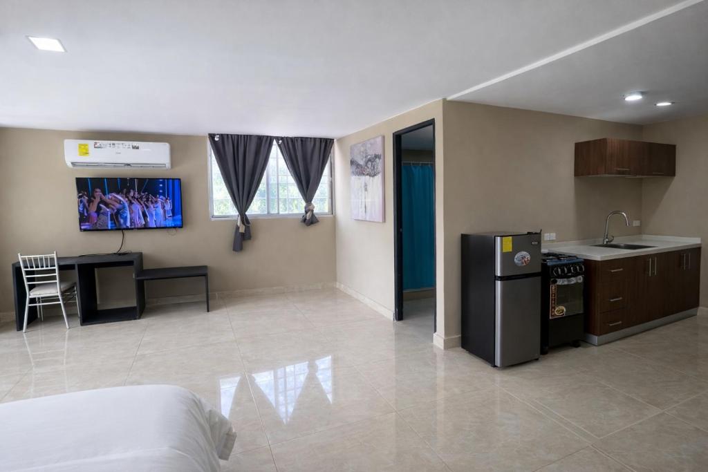 a kitchen with a refrigerator and a table in a room at Gorgona Beach House in Nueva Gorgona