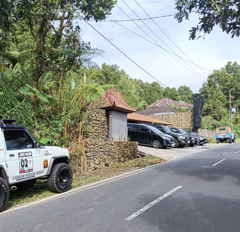 a white truck parked on the side of a street at Sang Natha Lodge - Kopi Tiam & Agro in Tjatur