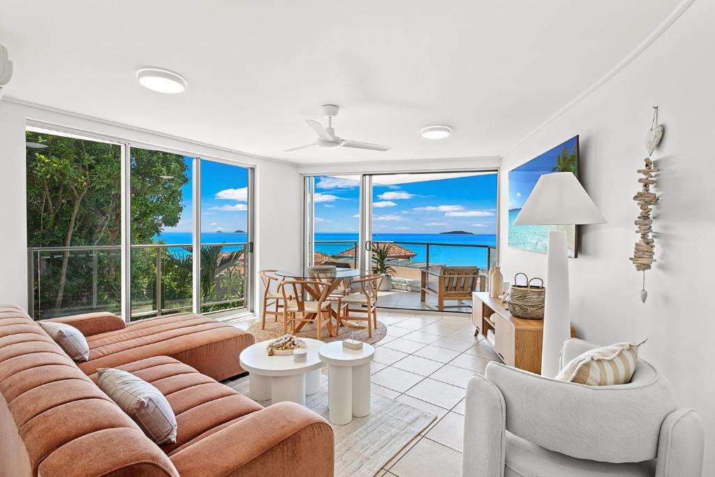 a living room with a couch and chairs at Searene By The Sea in Airlie Beach