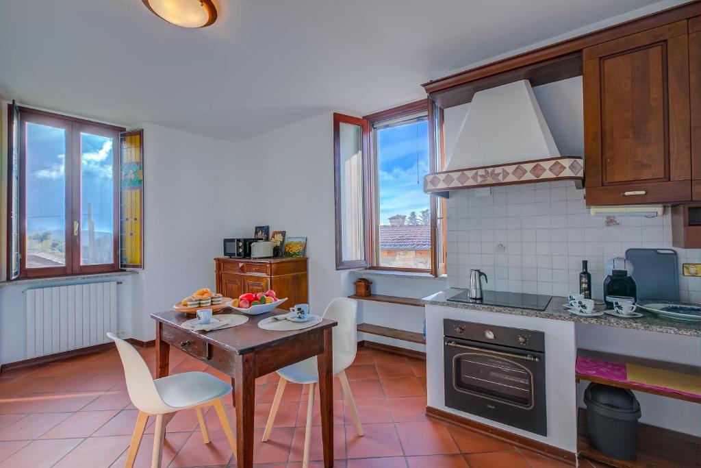 a kitchen with a table and chairs and a counter top at Casa al Castello in Leggiuno with Garden - Happy Rentals in Leggiuno