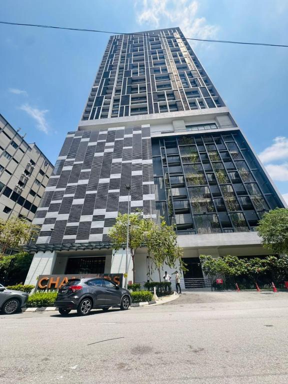 a tall building with cars parked in front of it at Chamber Haven KLCC in Kuala Lumpur