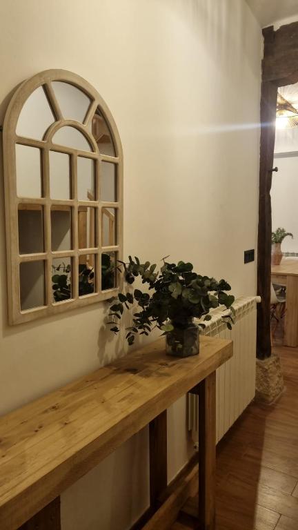 a room with a wooden table with a plant on it at Casa Rural Doña Aba in Espinosa de los Monteros