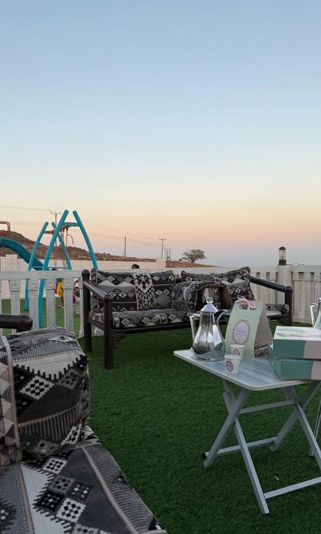 a patio with a couch and a table and a playground at إستراحة حجيف فيو in Salalah