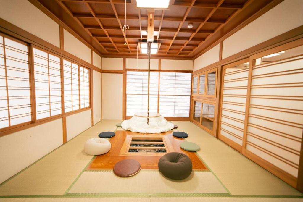 a room with a table and some windows at Morioka base モリオカベース in Morioka