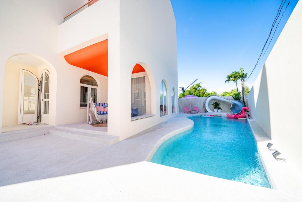 a swimming pool in a house with a water slide at Candy House Private Pool Villa & KTV in Ban Nong Chaeng