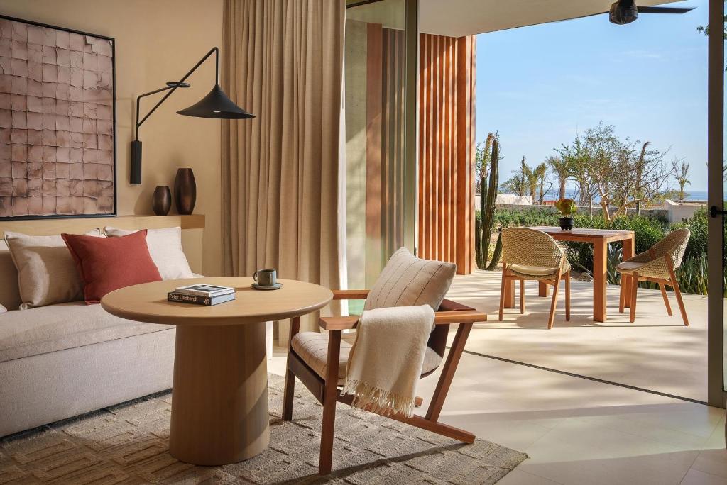 a living room with a couch and a table and chairs at Park Hyatt Cabo Del Sol in Cabo San Lucas