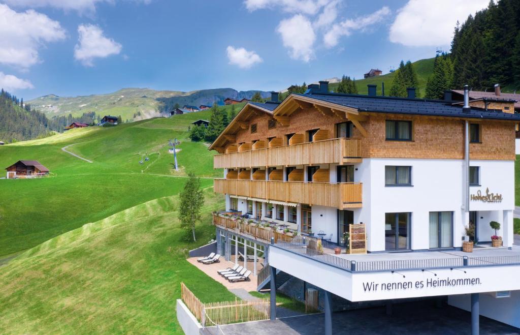 a hotel with a view of a golf course at Boutique Hotel Hohes Licht in Damuls