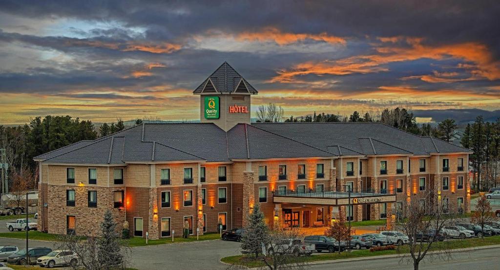 a large building with a clock tower on top of it at Quality Inn & Suites in Val-dʼOr