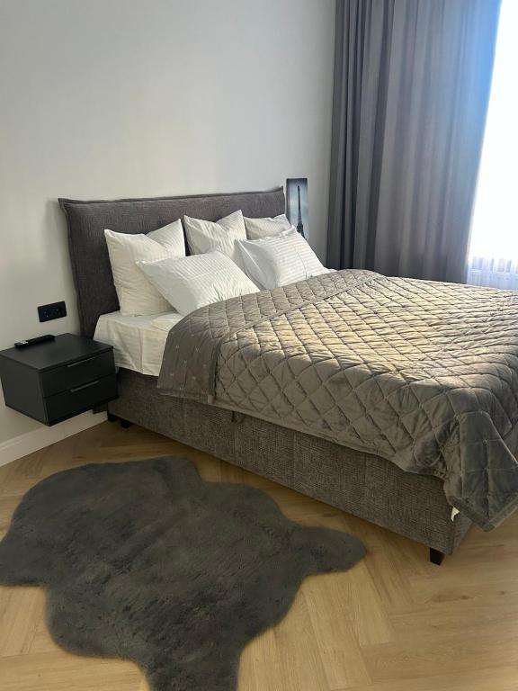 a bedroom with a bed and a rug on the floor at Квартира подобово класу "ЛЮКС" in Khmelnytskyi