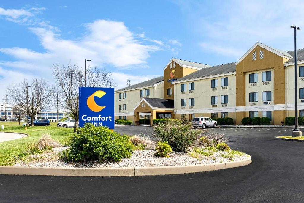 a sign in front of a building with a contract sign at Comfort Inn Evansville East in Evansville