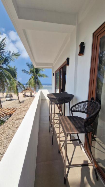 a balcony with two tables and a view of the beach at yamba pacifico in San Isidro